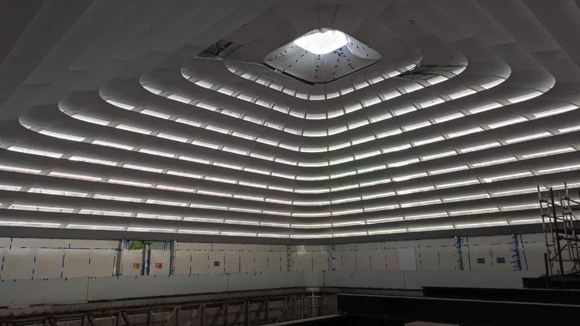 Concentric ceiling ribs lit for the first time around the skylight