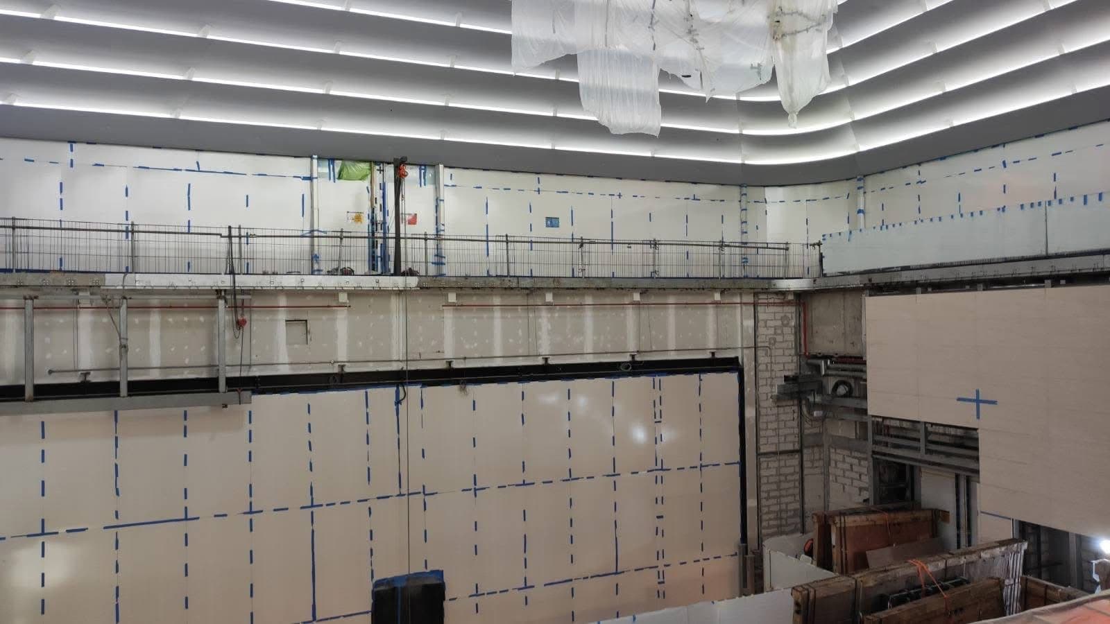 Forum wall with its large framed opening during construction