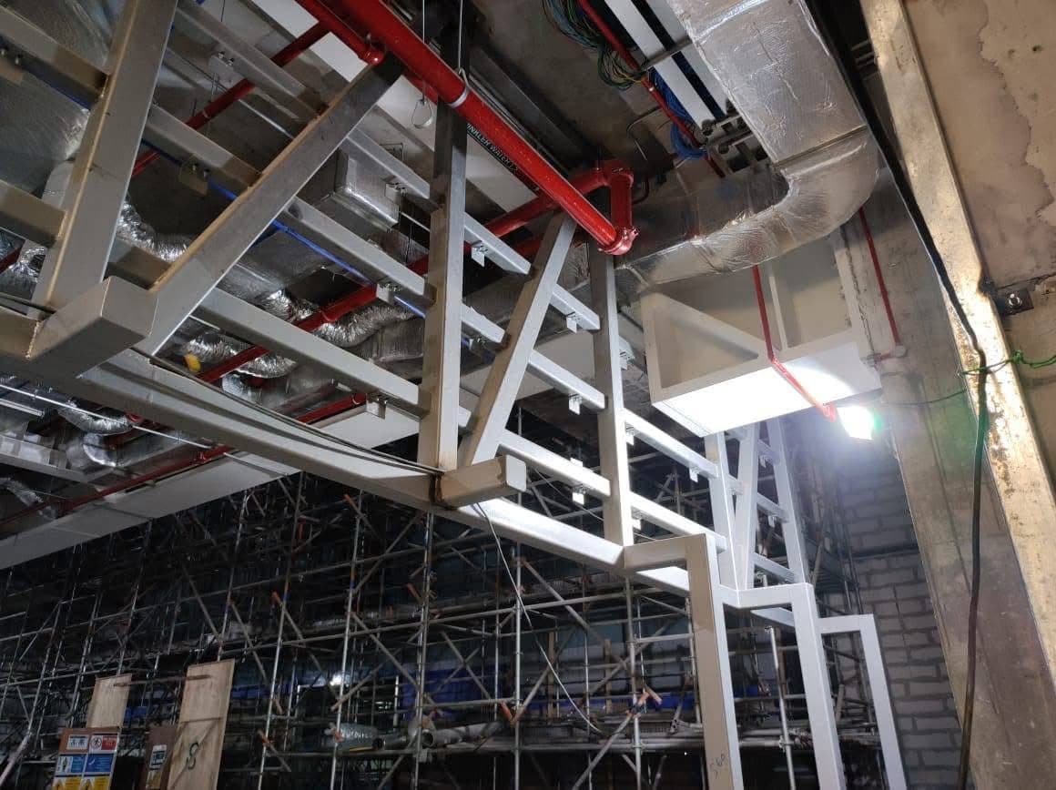Galvanised steel hanger frames suspended from the existing slab above