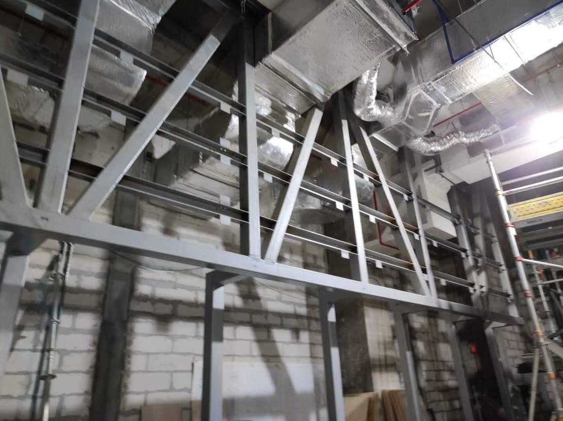 Diagonal steel bracing within the ceiling support framework