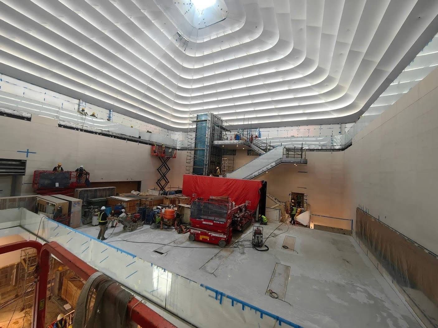 Upper atrium under construction with lifts, scaffold and the finished ceiling above